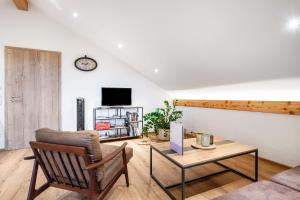 a living room with a couch and a table at Wohnung Staufenblick in Freilassing