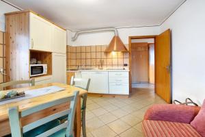 a kitchen with a wooden table and a dining room at Lovin Summer in Livigno +20 photos
