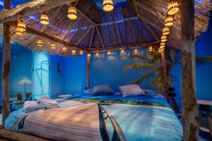 a bedroom with a large bed with a thatched roof at Hotel Art Village in Casoria +256 photos