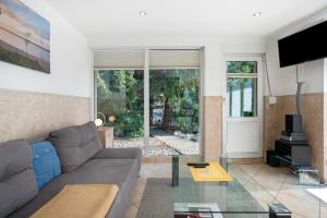 a living room with a couch and a glass table at Ferienanlage in Großkoschen