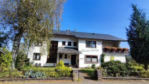 a white house with a sign that reads main glue at Haus Erika in Stryck