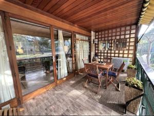 a screened in porch with a table and chairs at Eden Mar Calonge Girona in Calonge