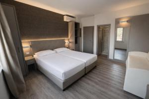 a bedroom with a large white bed in it at LVG Hotel Collection - Principe in Modena