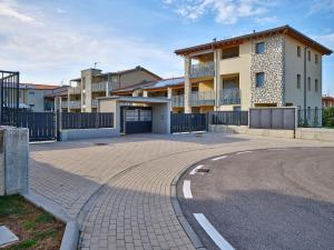 a parking lot in front of a building with a driveway at New Casa Augusto in Lazise