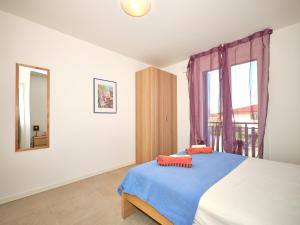 a bedroom with a bed and a mirror and a window at New Casa Augusto in Lazise +25 photos