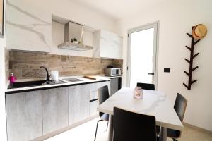 a kitchen with a table and chairs in a room at Casa Malika a Otranto in Otranto