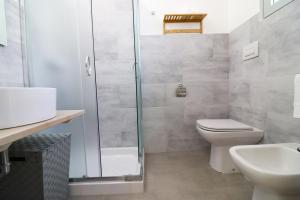 a bathroom with a shower and a toilet and a sink at Casa Malika a Otranto in Otranto +12 photos