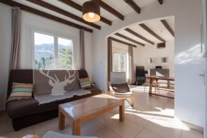 a living room with a couch and a table at Domaine de l'Arbizon in Bagnères-de-Bigorre