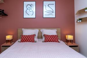 a bedroom with a bed with three pictures on the wall at Appart Anglet in Anglet