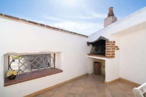 a room with a window and a brick fireplace at Giojas125 Monolocale per 4 persone in Orosei