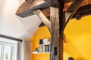 ein Holzbalken in einem Zimmer mit einem Bücherregal in der Unterkunft Bücherträume in Windeby