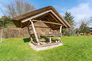ein überdachter Picknickplatz auf dem Rasen in der Unterkunft Bücherträume in Windeby