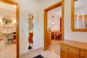 a kitchen and dining room with a large mirror at Schwarzbauernhof in Eschlkam +77 photos