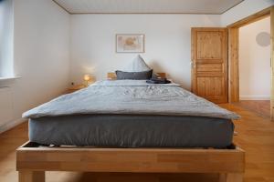 a bedroom with a large bed with a wooden frame at Ferien-Monteurwohnung Kaiser in Uelzen