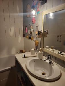 a bathroom with a sink and a mirror and a tub at Échoppe Saint Augustin in Bordeaux +1 photo