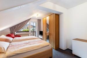 a bedroom with a large bed and a window at Haus Erika in Stryck