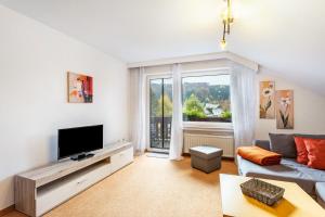 a living room with a couch and a tv at Haus Erika in Stryck