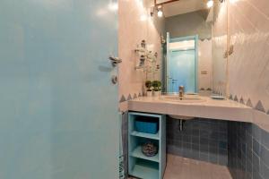 a bathroom with a sink and a mirror at Casa Erica in Stintino
