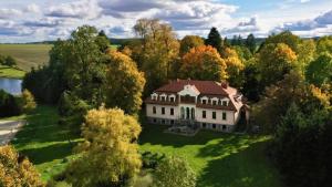 an aerial view of a large house in the trees at Kuźnia-Grodno in Krzywa Wieś