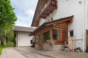 a wooden building with a balcony on the side at Paracia App La Vedla in Badia