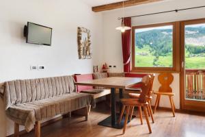 a living room with a couch and a table at Paracia App La Vedla in Badia