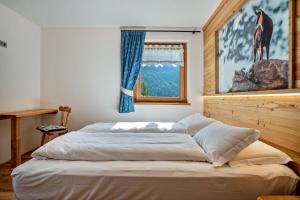 a large bed in a bedroom with a window at La Chiasa in Rabbi