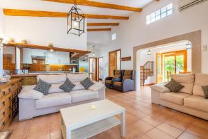 a living room with two couches and a kitchen at Son Sant Joan in Alaró