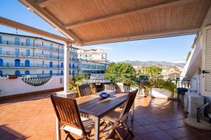 a patio with a table and chairs on a balcony at Casa Vacanza Giugiò in Giardini Naxos