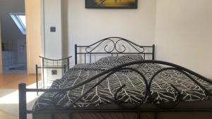 a bedroom with a bed with a metal frame at Wohnung an der Galopprennbahn in Iffezheim