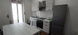 a kitchen with a black refrigerator and a counter top at Alloggio Tobia in Biella