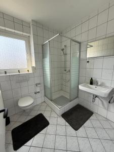 a bathroom with a shower and a sink and a toilet at Schöne 3 Zimmer Wohnung in Bad Salzuflen in Bad Salzuflen