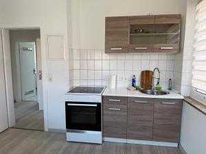 a kitchen with a sink and a stove top oven at Schöne 3 Zimmer Wohnung in Bad Salzuflen in Bad Salzuflen