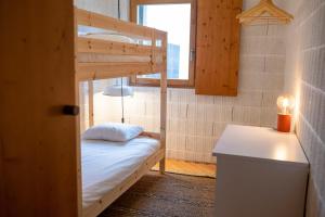 a small room with a bunk bed and a window at Fisherman's Blues - Beach House in Arcozelo