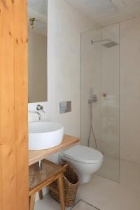 a bathroom with a sink and a toilet and a shower at Fisherman's Blues - Beach House in Arcozelo