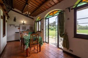 a dining room with a table and glass doors at Tenuta Donna Vittoria in Trapani