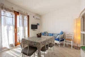 a living room with a table and chairs and a couch at Casa Orimar 419 in Badesi