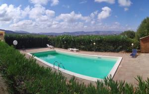a swimming pool in a yard with a view at Casa Orimar 419 in Badesi