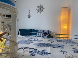 a bedroom with a bed with a blue and white blanket at Casa Orimar 419 in Badesi +23 photos