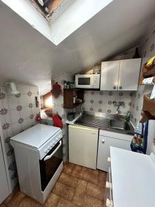 a small kitchen with a stove and a sink at Trilocale Einaudi Bardonecchia in Bardonecchia