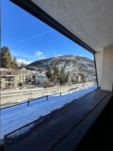 a window in a building with a view of a mountain at Trilocale Einaudi Bardonecchia in Bardonecchia