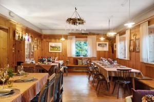 a dining room with long tables and chairs at Alter Fausthof in Fie allo Sciliar