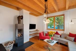 a living room with a red couch and a fireplace at Lug ins Tal - Ferienhaus in Baiersbronn