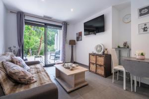 a living room with a couch and a table at Studio moderne tout confort in La Valette-du-Var