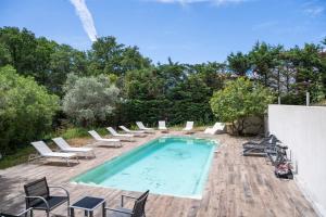 a pool with chaise lounge chairs and a bunch at Studio moderne tout confort in La Valette-du-Var