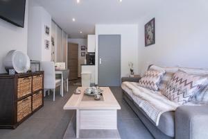 a living room with a couch and a table at Studio moderne tout confort in La Valette-du-Var +13 photos