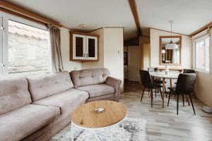 a living room with a couch and a table at Villa Hexenholz in Thale