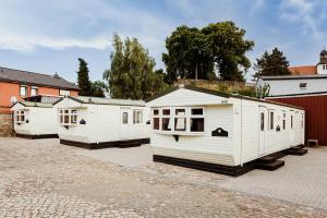 a row of white buildings parked in a parking lot at Villa Hexenholz in Thale