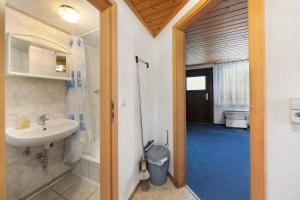 a bathroom with a sink and a shower and a toilet at Bungalow 19 - Kimbucht in Reichendorf
