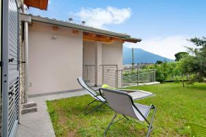 a pair of chairs and a table on a patio at Jack House in Domaso