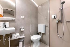 a small bathroom with a toilet and a shower at Alter Fausthof in Fie allo Sciliar +56 photos